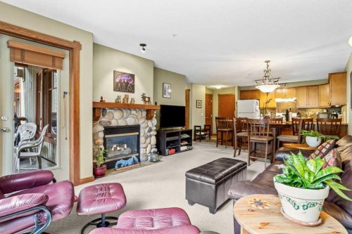 215-150 Crossbow Place, Canmore, AB - Indoor Photo Showing Living Room With Fireplace