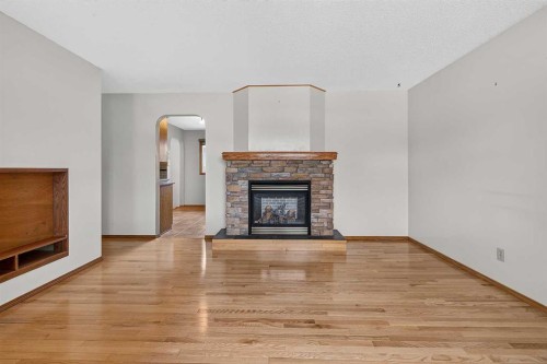 4639 Marbank Drive, Calgary, AB - Indoor Photo Showing Living Room With Fireplace