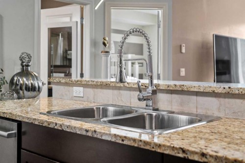 3106-15 Sunset Square, Cochrane, AB - Indoor Photo Showing Kitchen With Double Sink With Upgraded Kitchen