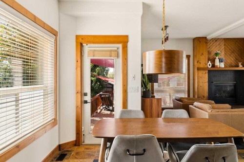 115 Rockmont Court Nw, Calgary, AB - Indoor Photo Showing Dining Room With Fireplace