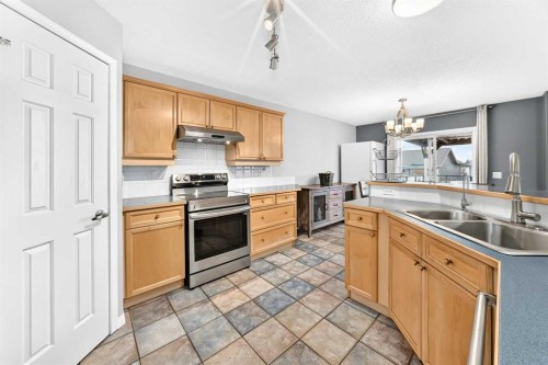 23 Thornbird Way Se, Airdrie, AB - Indoor Photo Showing Kitchen With Double Sink