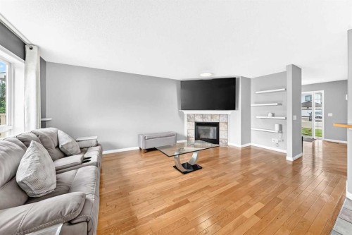 23 Thornbird Way Se, Airdrie, AB - Indoor Photo Showing Living Room With Fireplace