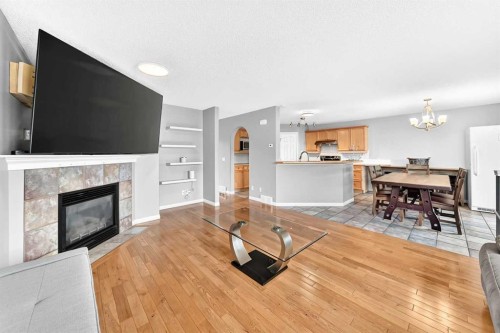 23 Thornbird Way Se, Airdrie, AB - Indoor Photo Showing Living Room With Fireplace
