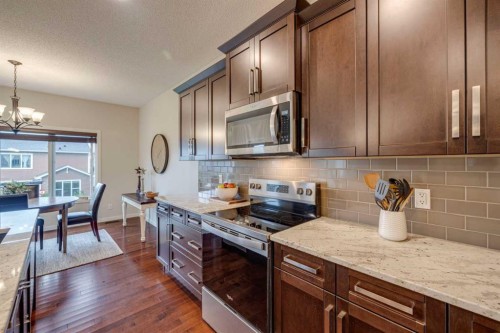 150 Fireside Bend, Cochrane, AB - Indoor Photo Showing Kitchen With Upgraded Kitchen