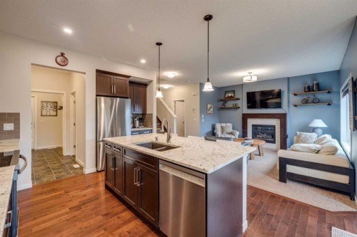 150 Fireside Bend, Cochrane, AB - Indoor Photo Showing Kitchen With Fireplace With Double Sink With Upgraded Kitchen