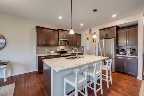 150 Fireside Bend, Cochrane, AB - Indoor Photo Showing Kitchen With Double Sink With Upgraded Kitchen