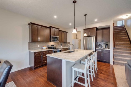 150 Fireside Bend, Cochrane, AB - Indoor Photo Showing Kitchen With Upgraded Kitchen