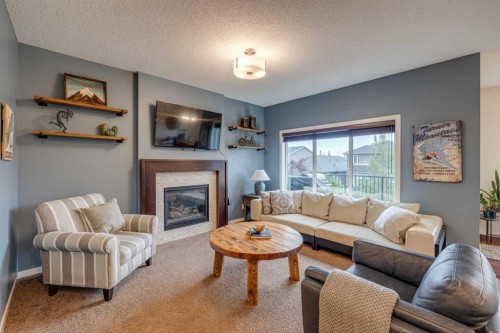150 Fireside Bend, Cochrane, AB - Indoor Photo Showing Living Room With Fireplace