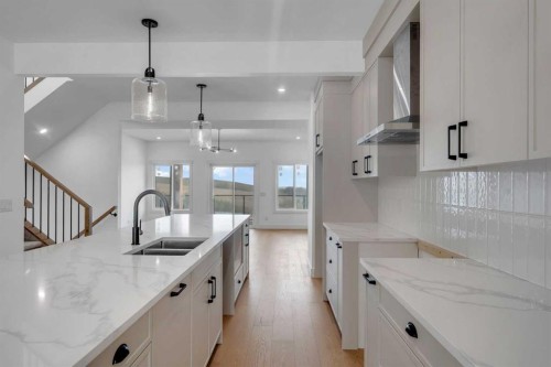 39 Heritage Ridge, Cochrane, AB - Indoor Photo Showing Kitchen With Double Sink With Upgraded Kitchen