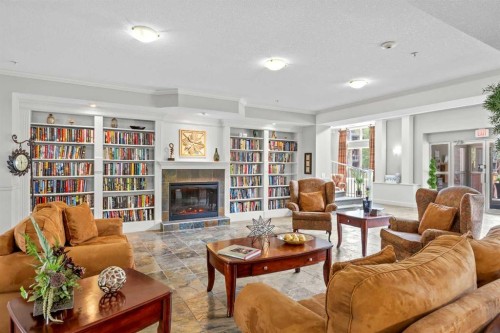 225-15 Everstone Drive Sw, Calgary, AB - Indoor Photo Showing Living Room With Fireplace