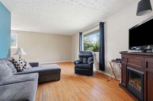 9032 Fairmount Drive Se, Calgary, AB - Indoor Photo Showing Living Room With Fireplace