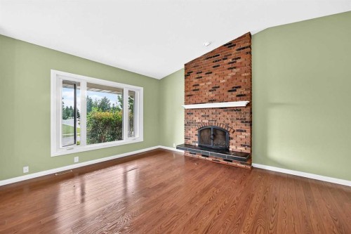 11335 Braeside Drive Sw, Calgary, AB - Indoor Photo Showing Living Room With Fireplace
