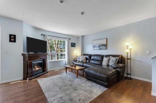 6-156 Canoe Drive Sw, Airdrie, AB - Indoor Photo Showing Living Room With Fireplace