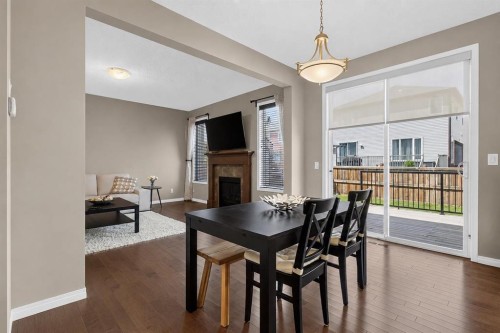 150 Osborne Rise Sw, Airdrie, AB - Indoor Photo Showing Dining Room With Fireplace