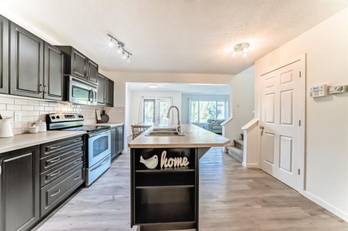 790 River Heights Crescent, Cochrane, AB - Indoor Photo Showing Kitchen With Stainless Steel Kitchen With Double Sink With Upgraded Kitchen