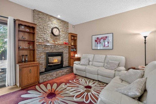 80 Hawkhill Way Nw, Calgary, AB - Indoor Photo Showing Living Room With Fireplace