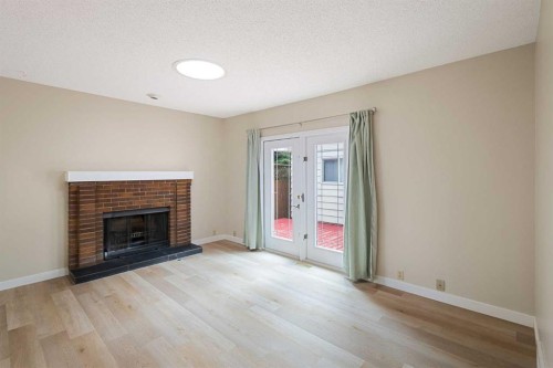 1111 Berkley Drive Nw, Calgary, AB - Indoor Photo Showing Living Room With Fireplace