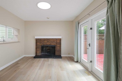 1111 Berkley Drive Nw, Calgary, AB - Indoor Photo Showing Living Room With Fireplace