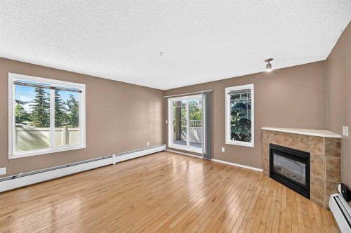 3109-70 Panamount Drive Nw, Calgary, AB - Indoor Photo Showing Living Room With Fireplace