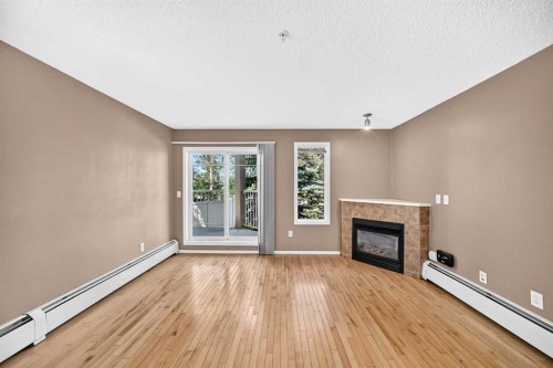 3109-70 Panamount Drive Nw, Calgary, AB - Indoor Photo Showing Living Room With Fireplace