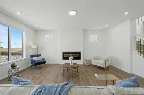 3034 Southwinds Place Sw, Airdrie, AB - Indoor Photo Showing Living Room With Fireplace