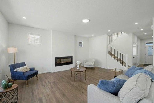 3034 Southwinds Place Sw, Airdrie, AB - Indoor Photo Showing Living Room With Fireplace