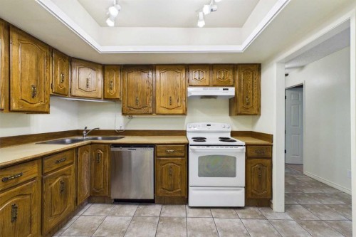 212-3730 50 Street Nw, Calgary, AB - Indoor Photo Showing Kitchen With Double Sink