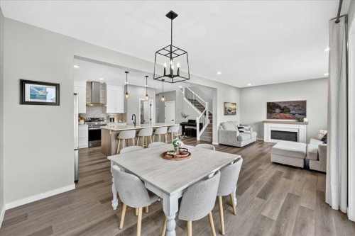 421 Magnolia Way Se, Calgary, AB - Indoor Photo Showing Dining Room With Fireplace
