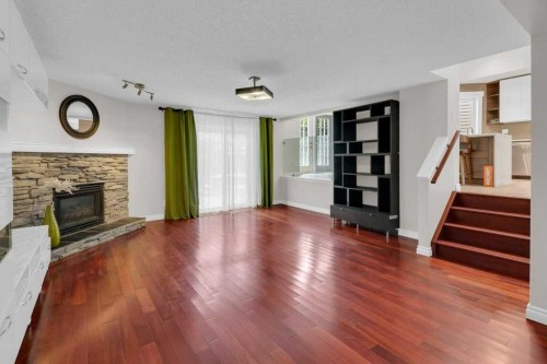 270 Arbour Ridge Park Nw, Calgary, AB - Indoor Photo Showing Living Room With Fireplace