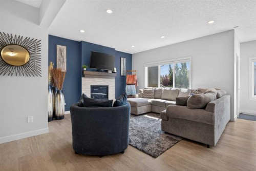 325 Bayside Crescent Sw, Airdrie, AB - Indoor Photo Showing Living Room With Fireplace