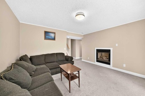 287 Harvest Oak Rise Ne, Calgary, AB - Indoor Photo Showing Living Room With Fireplace