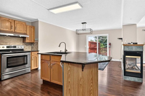 287 Harvest Oak Rise Ne, Calgary, AB - Indoor Photo Showing Kitchen With Fireplace