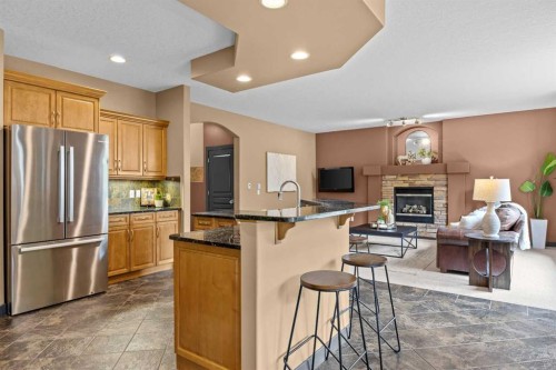 139 Tuscany Ridge Close Nw, Calgary, AB - Indoor Photo Showing Kitchen With Fireplace