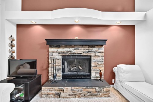 14954 Mt Mckenzie Drive Se, Calgary, AB - Indoor Photo Showing Living Room With Fireplace