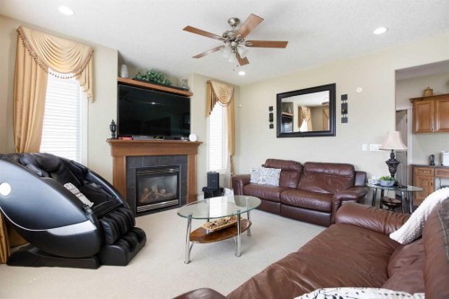 1149 Channelside Drive Sw, Airdrie, AB - Indoor Photo Showing Living Room With Fireplace