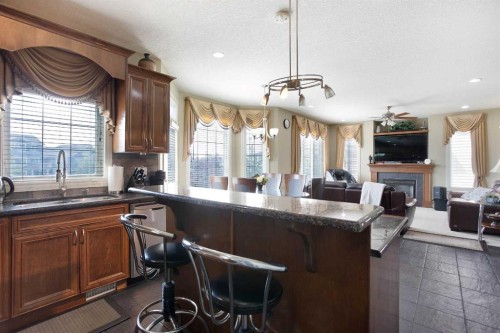1149 Channelside Drive Sw, Airdrie, AB - Indoor Photo Showing Kitchen With Fireplace