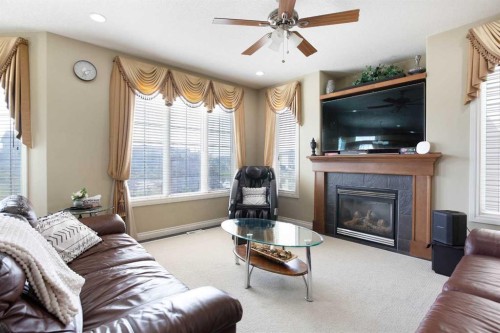 1149 Channelside Drive Sw, Airdrie, AB - Indoor Photo Showing Living Room With Fireplace
