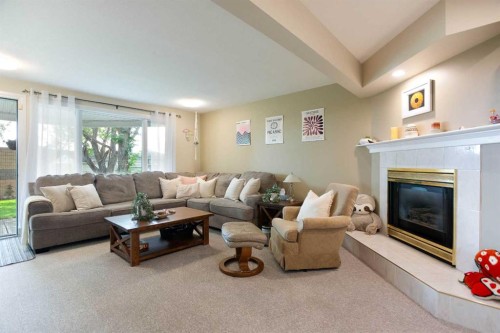 128 Waterstone Place Se, Airdrie, AB - Indoor Photo Showing Living Room With Fireplace