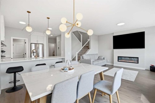 143 Belvedere Crescent Se, Calgary, AB - Indoor Photo Showing Dining Room With Fireplace