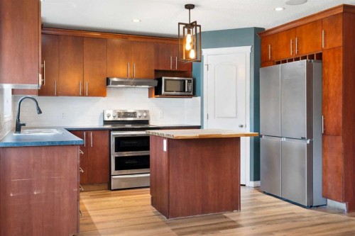 128 Silverado Way Sw, Calgary, AB - Indoor Photo Showing Kitchen With Double Sink