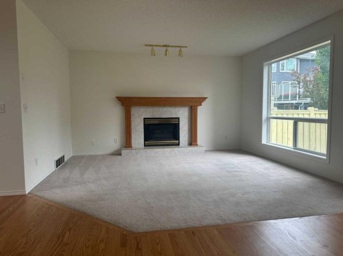 151 Citadel Green Nw, Calgary, AB - Indoor Photo Showing Living Room With Fireplace