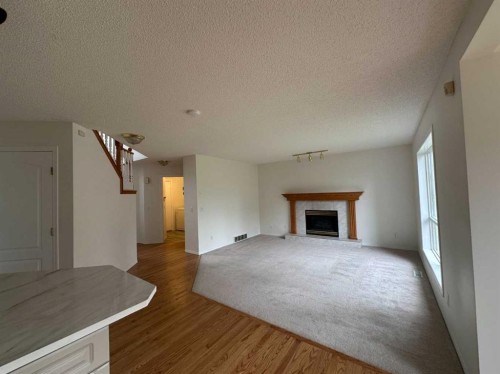 151 Citadel Green Nw, Calgary, AB - Indoor Photo Showing Living Room With Fireplace