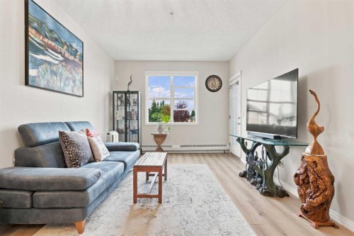 208-25 Prestwick Drive Se, Calgary, AB - Indoor Photo Showing Living Room