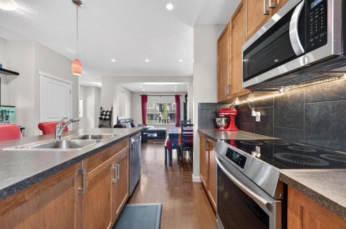 218 River Heights Green, Cochrane, AB - Indoor Photo Showing Kitchen With Double Sink