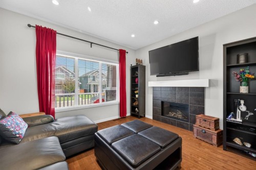 218 River Heights Green, Cochrane, AB - Indoor Photo Showing Living Room With Fireplace