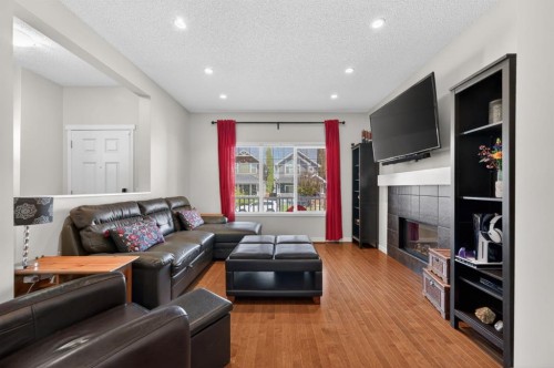 218 River Heights Green, Cochrane, AB - Indoor Photo Showing Living Room With Fireplace