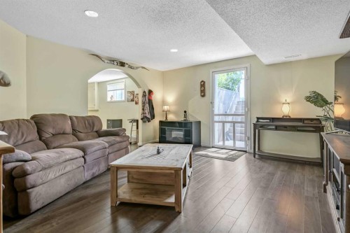 443 Riverside Green Nw, High River, AB - Indoor Photo Showing Living Room With Fireplace