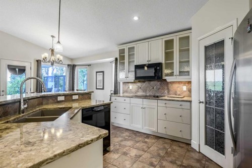443 Riverside Green Nw, High River, AB - Indoor Photo Showing Kitchen With Double Sink
