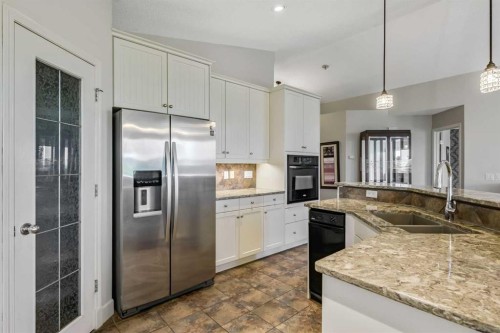443 Riverside Green Nw, High River, AB - Indoor Photo Showing Kitchen With Double Sink