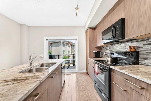 7 Stonehouse Crescent Nw, High River, AB - Indoor Photo Showing Kitchen With Double Sink